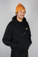 A unisex hoodie, available in black or white, made from eco-friendly materials - a blend of organic cotton and recycled polyester.. On the back of the hoodie is a geometric design of whales and mountains, giving the product a unique and stylish touch gives. The fabric is soft and comfortable, giving the wearer a cozy feeling. Suitable for environmentally conscious consumers, the hoodie promotes sustainable fashion.