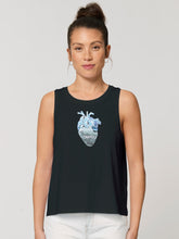 A women's black high-neck tank top featuring a geometric whale and a realistic wave heart design. The sleeveless top has a figure-hugging cut and reaches to the middle of the hips. The graphic design features a geometric whale and a realistic heart with waves, giving the product a unique and stylish touch. The fabric is soft and comfortable, giving the wearer a comfortable feeling. The product is suitable for environmentally conscious consumers and promotes sustainable fashion.